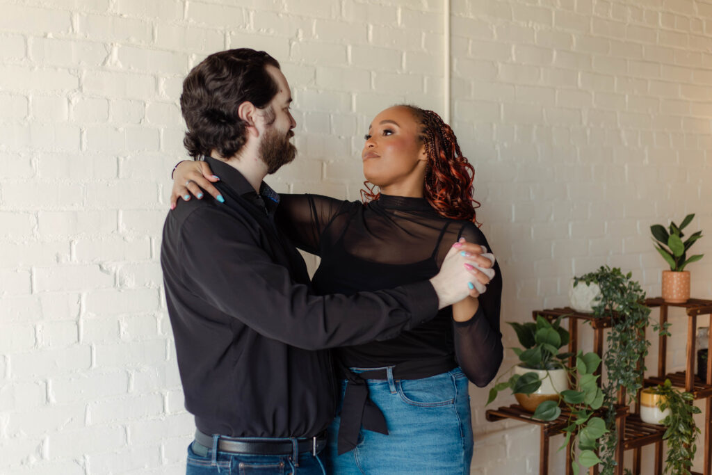 Engaged couple slow dancing during a photoshoot at Opal Bay Studio in Augusta, Georgia