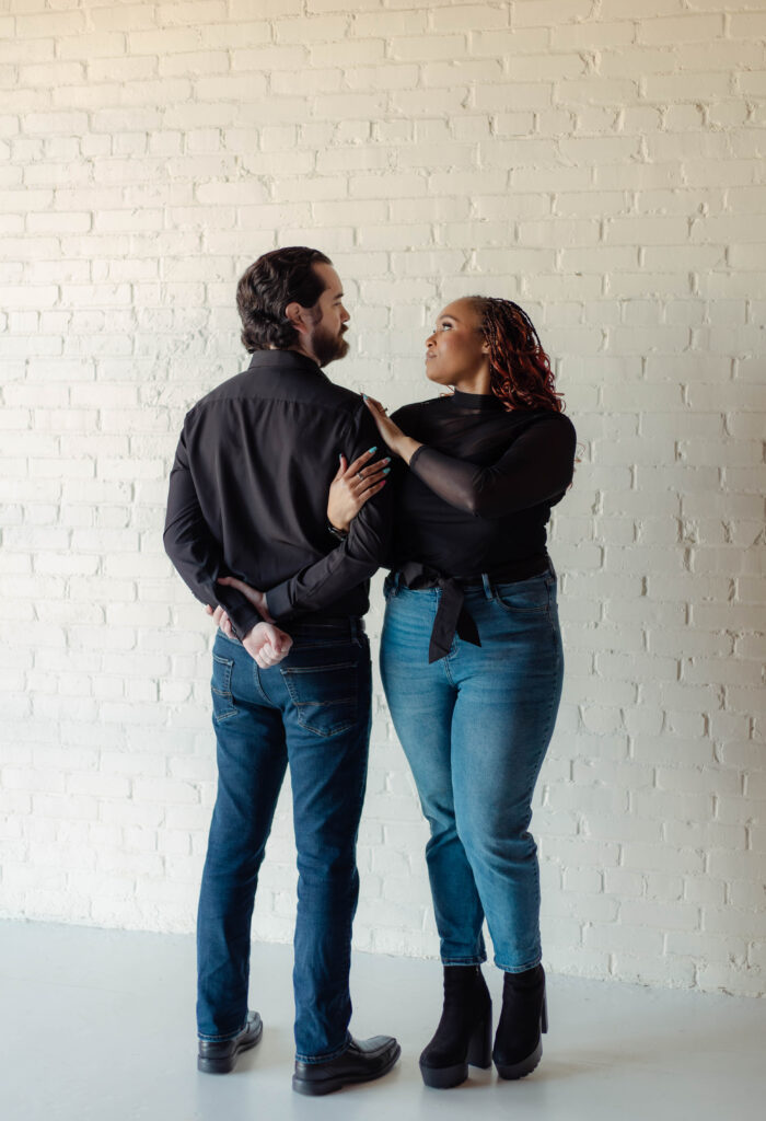 Engaged couple standing close during their studio engagement session in Augusta, Georgia