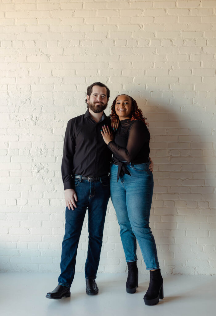 Engaged couple smiling during their photoshoot at Opal Bay Studio in Augusta, Georgia