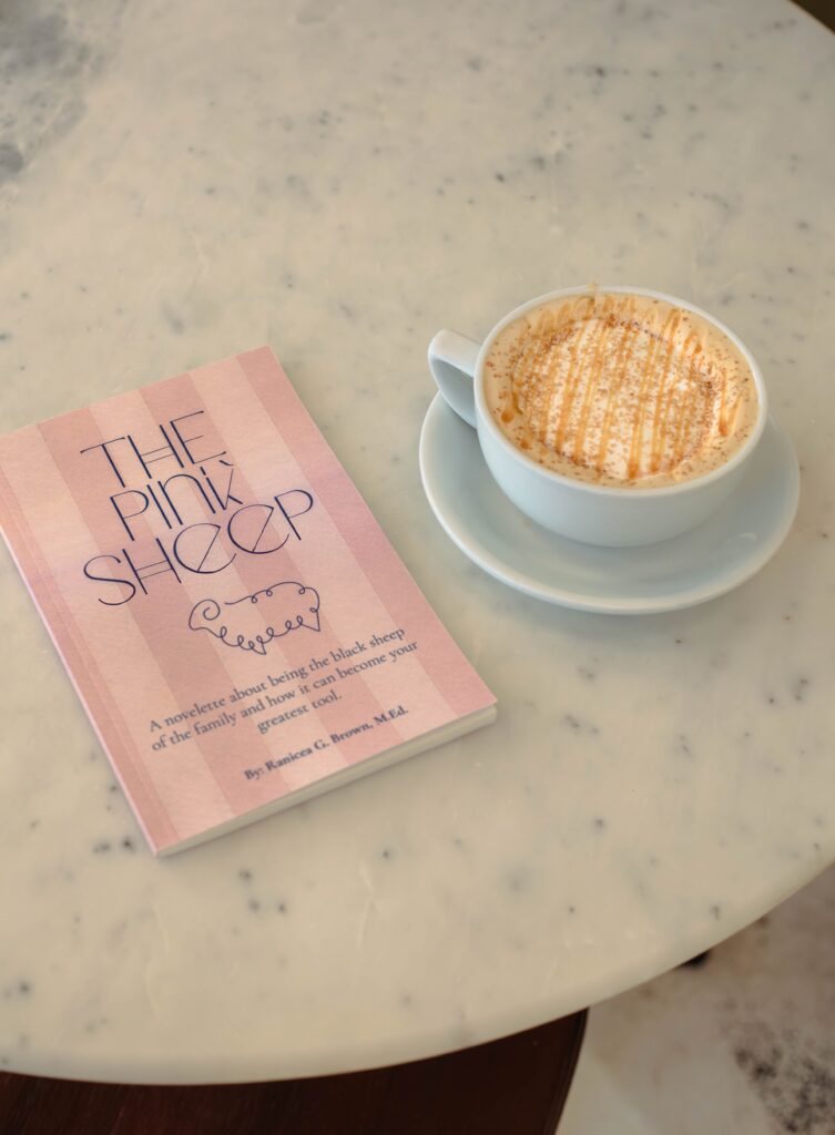 Coffee cup and book on a table during a cozy branding photoshoot