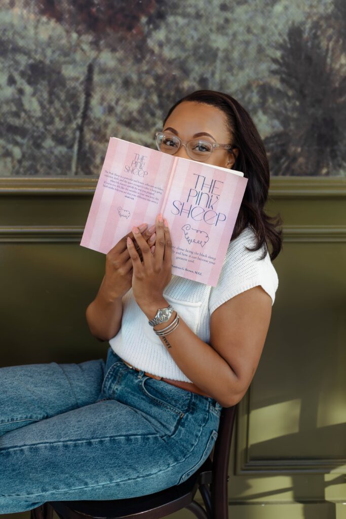Author holding book while only showing her eyes for branding session