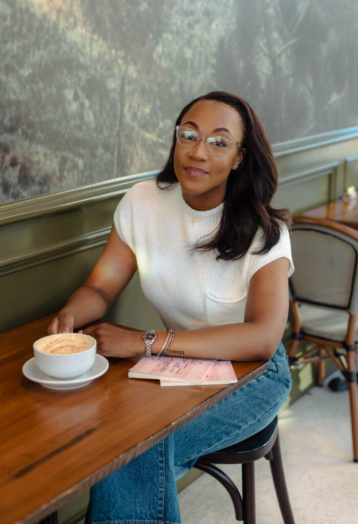 Author sitting with coffee and her book at branding session