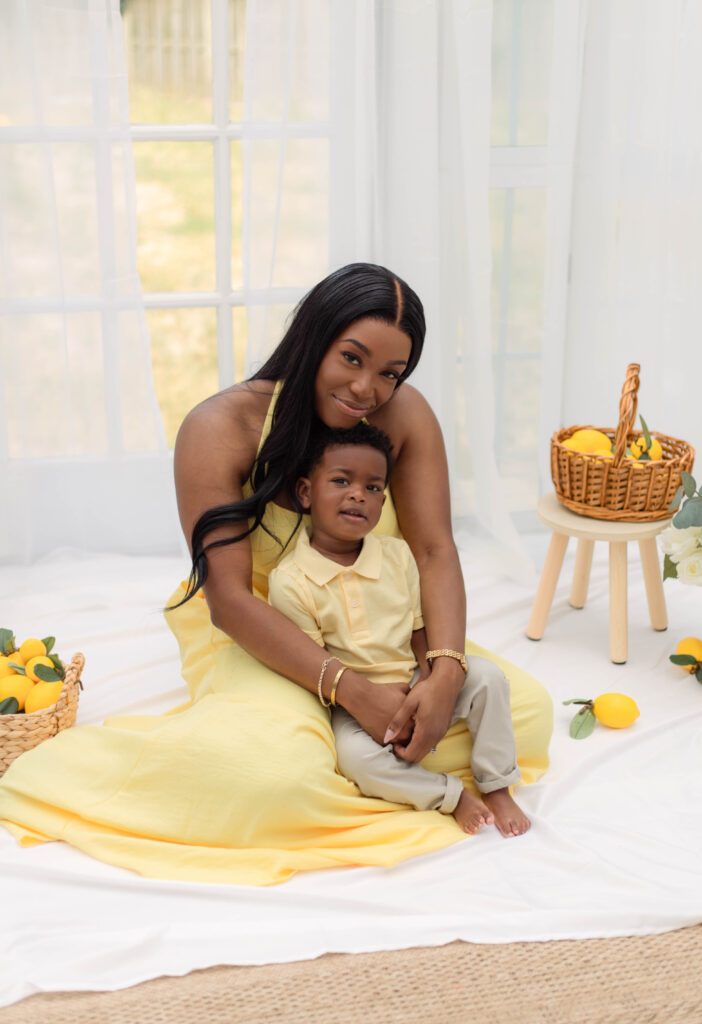 Mom hugs her baby boy in her lap for photo session