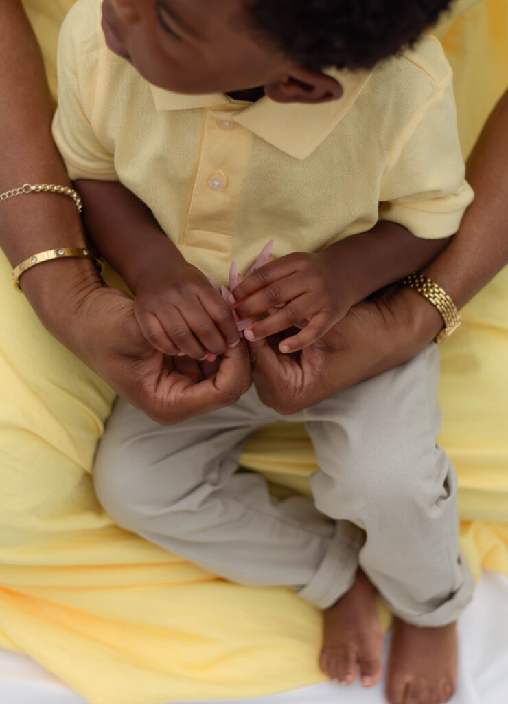 Close up of a mother holding her son's tiny hands