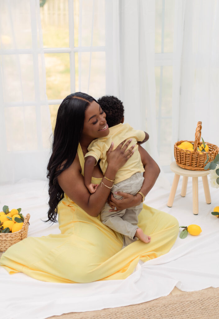 Mom hugs her son while wearing yellow