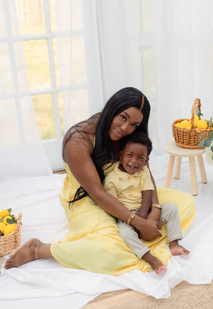 Mother holds son while he laughs at the camera