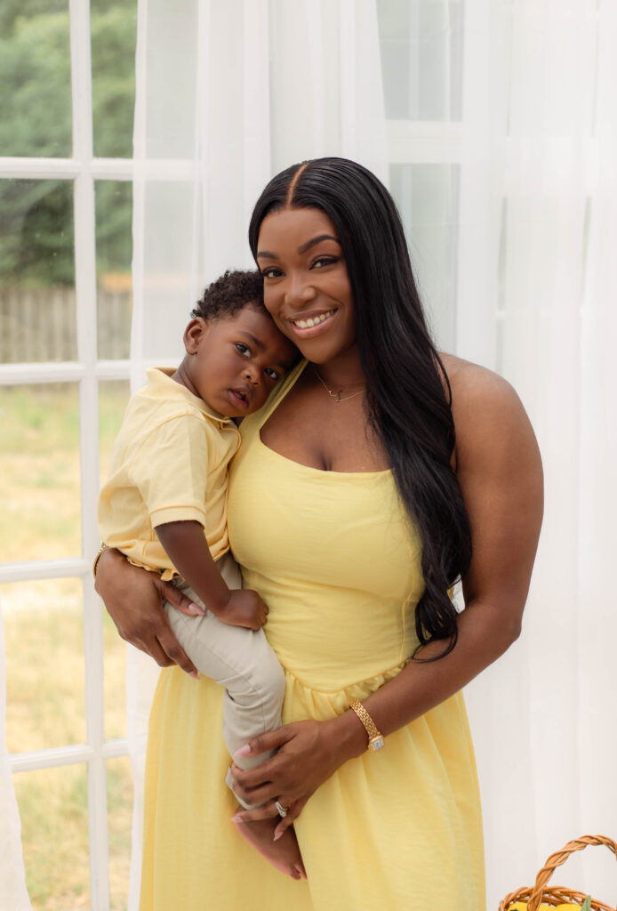 Mom holds her son with a smile