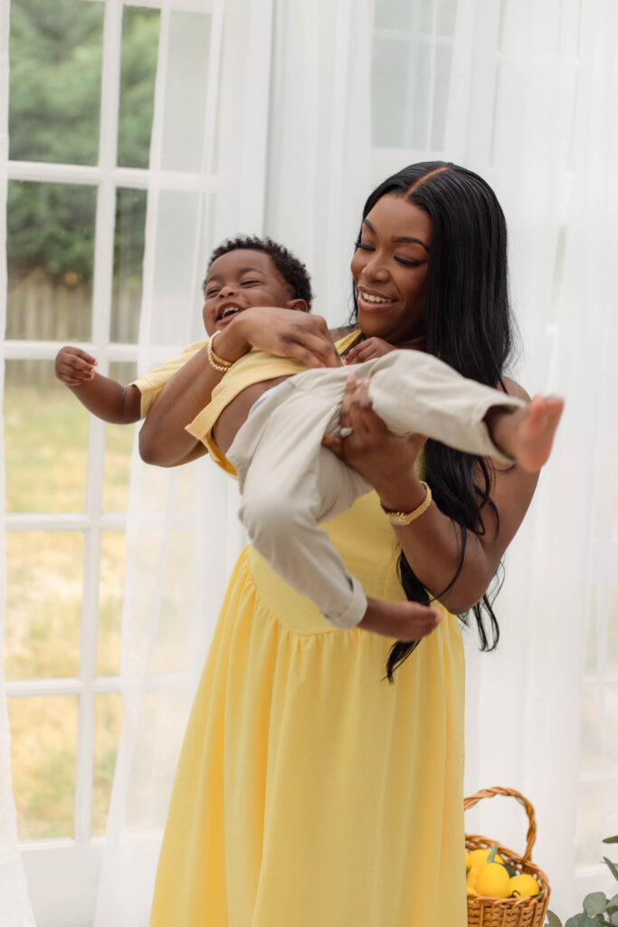 Mom spins her baby around to cause him to laugh