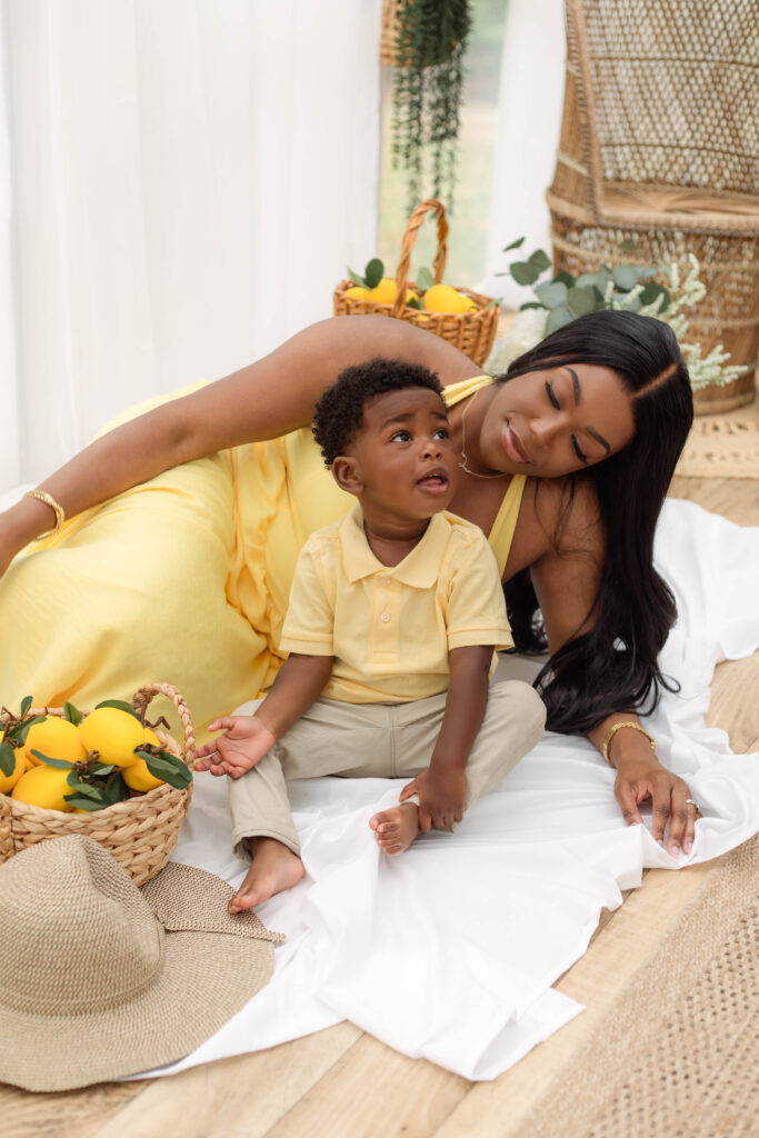 Mother and son sitting together on a white sheet