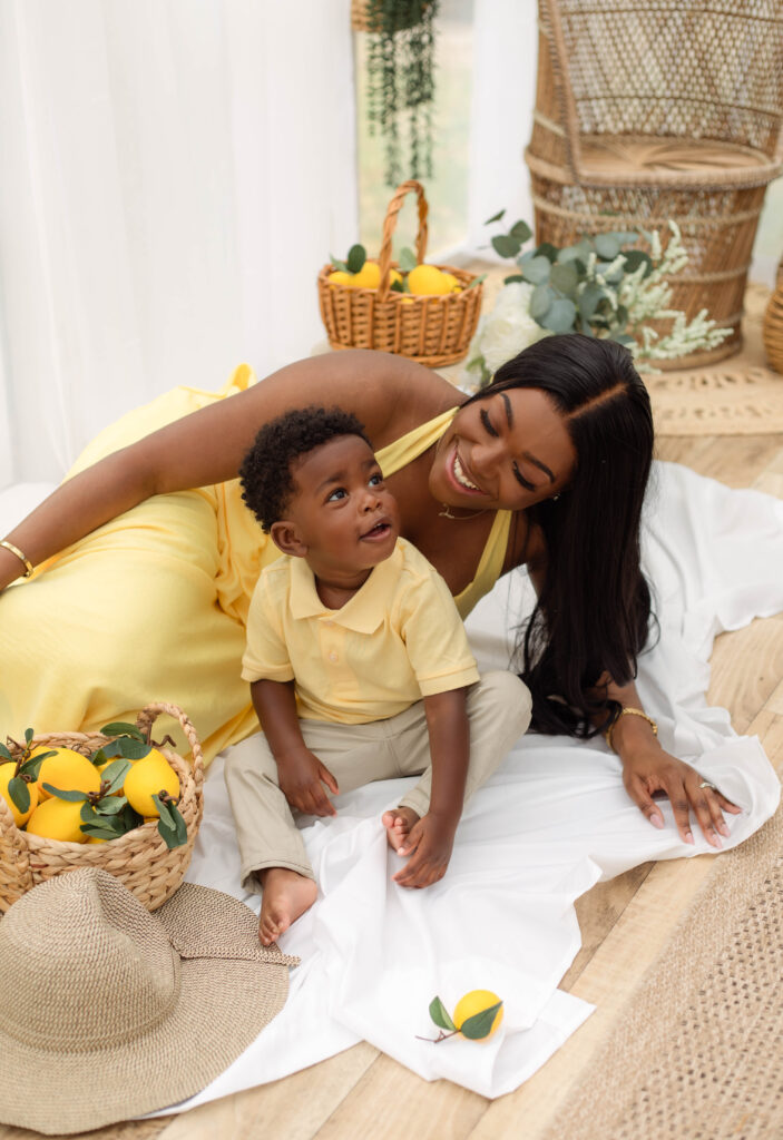 Mother and son smiling while laying and sitting together