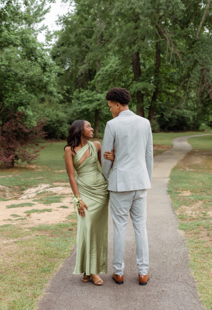 Couple posing for photos together before prom