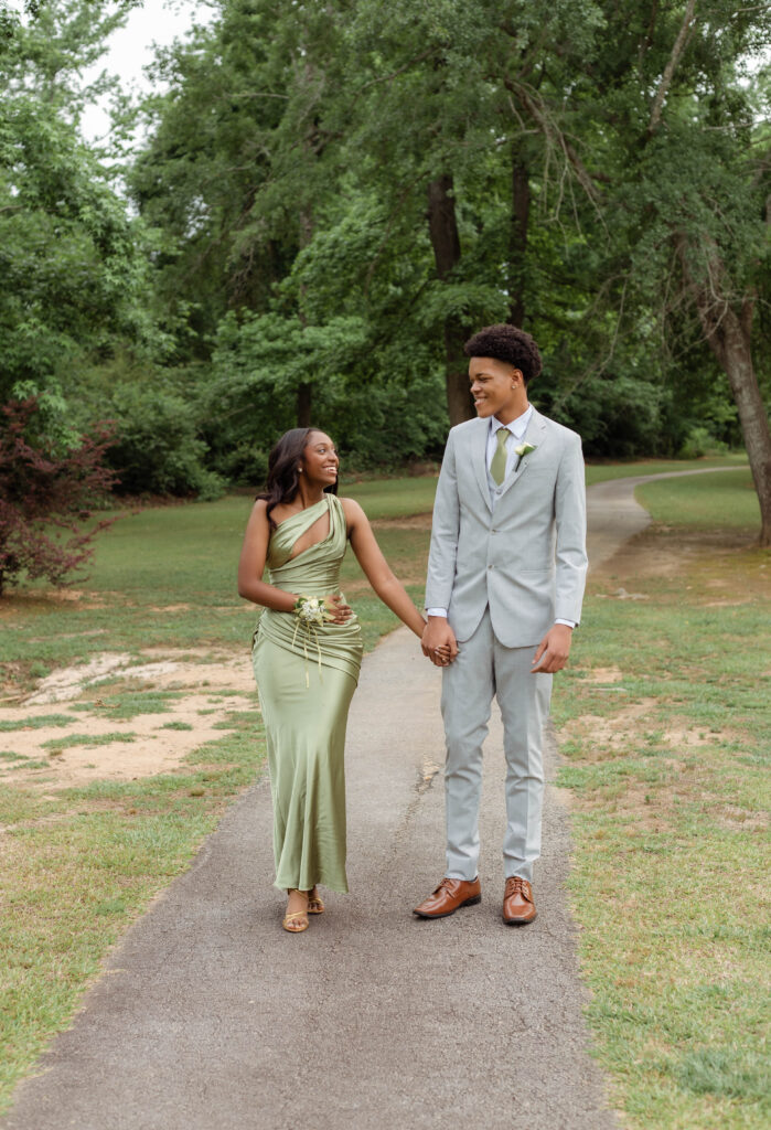 Prom couple walking together for photos