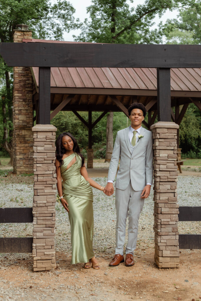 Couple holding hands while posing for photo