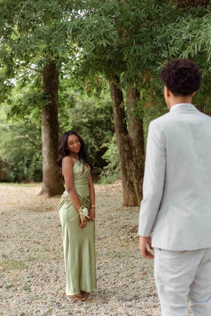 Young man looks at prom date for photos