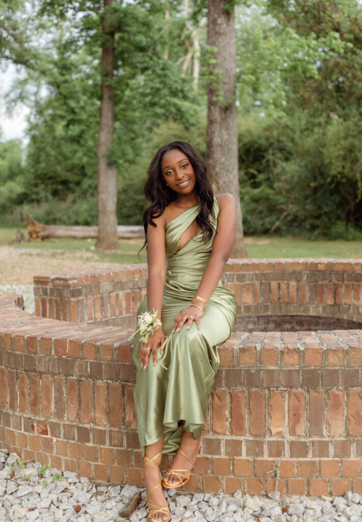 Young woman sitting for prom photos
