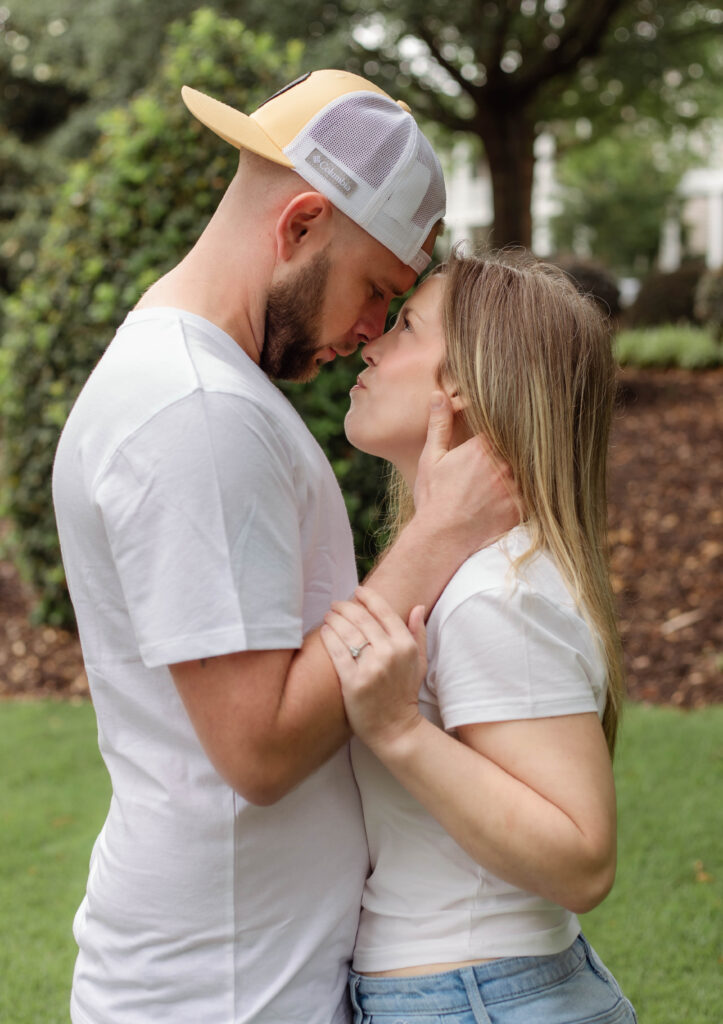 With foreheads together, an engaged couples looks at each other