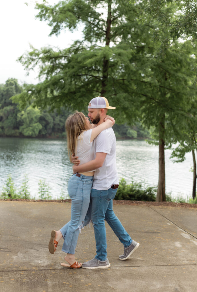 Engaged couple runs into a hug for photo session