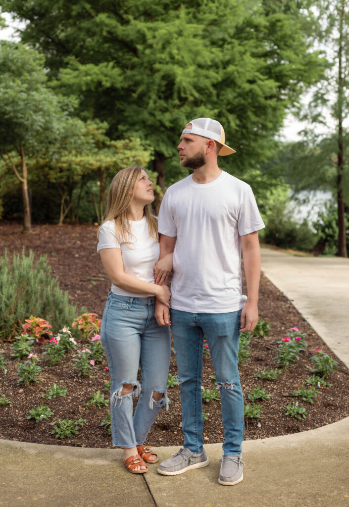 Woman looks at fiancé while holding onto his arm at Boeckh Park in North Augusta