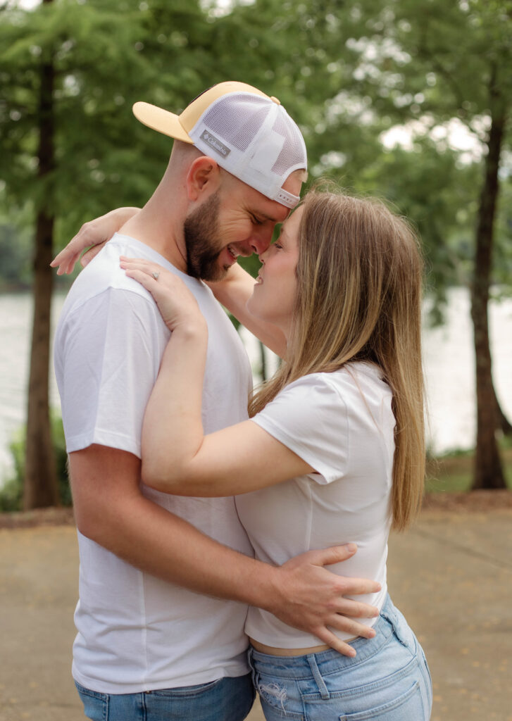 A couple smiling and touching noses at a photo session