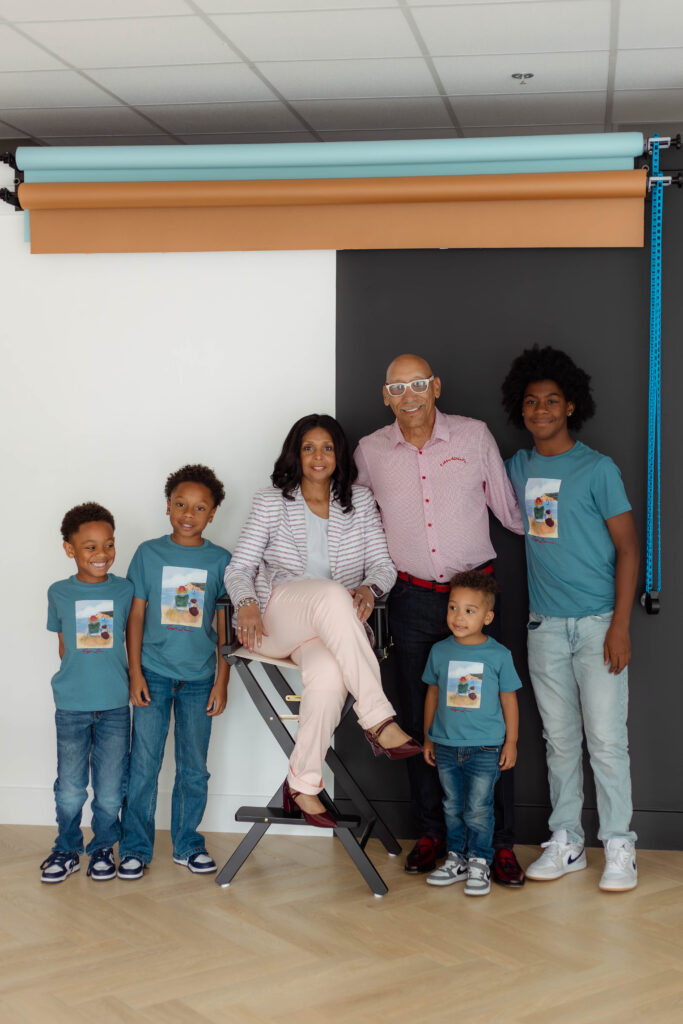 Grandparents smiling in a photo with their grandchildren