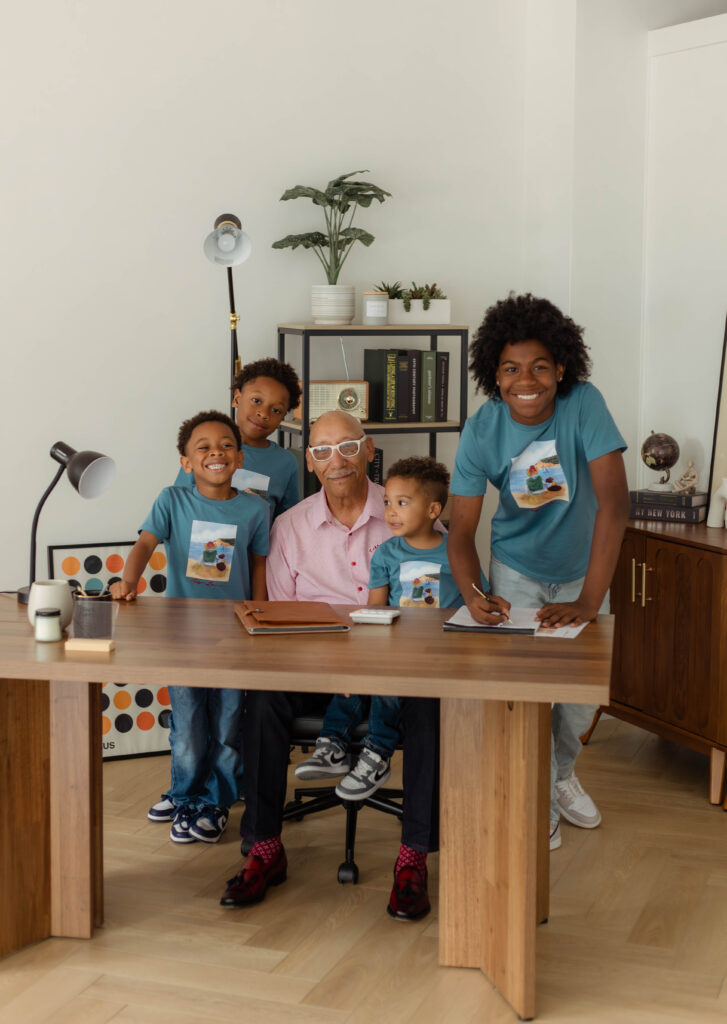 Grandpa and his grandkids smiling for a photo