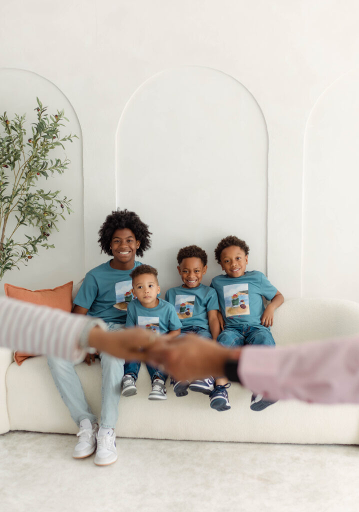A shot of grandchildren with their grandparent's hands out of focus