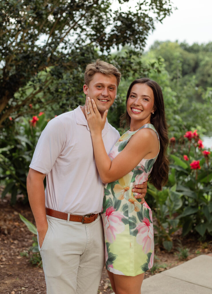 Woman holds fiancé's face while posing for photos