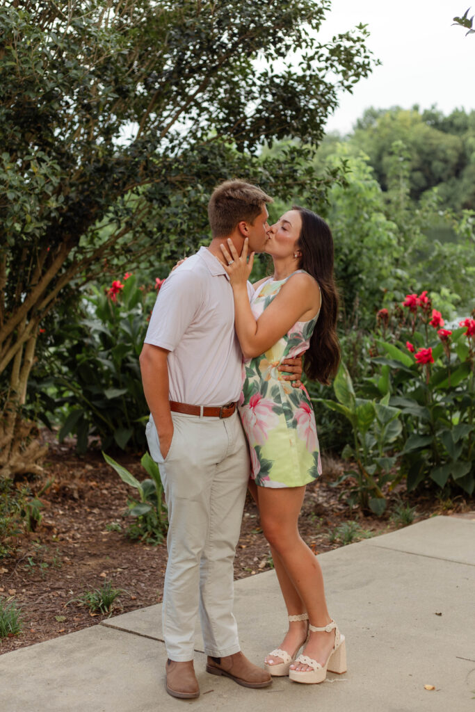 Engaged couple shares a kiss post-proposal