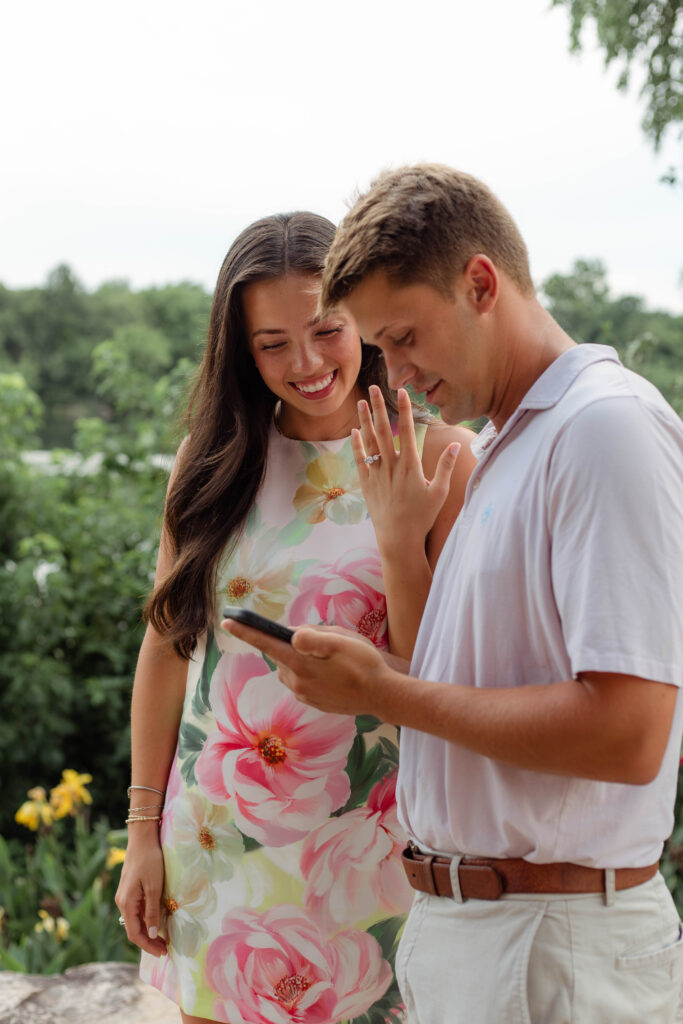 Couple shows off the ring while on the phone with a friend
