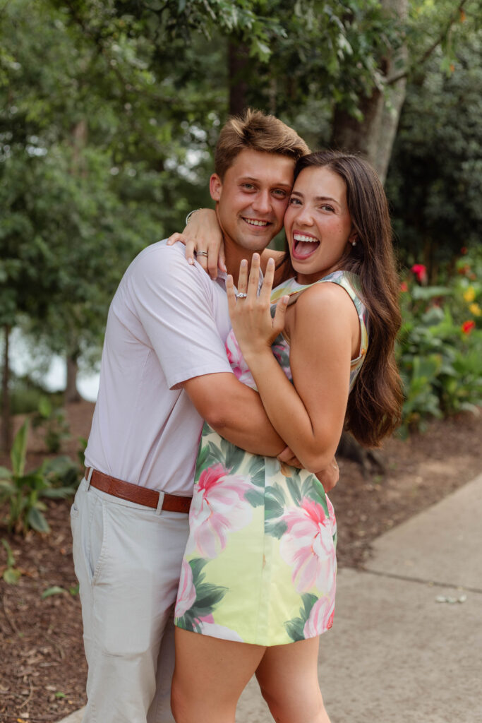 Engaged couple hugging excitedly in North Augusta, South Carolina