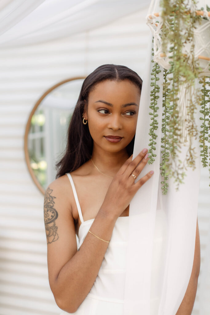 Up close photo of a model posing with a white curtain