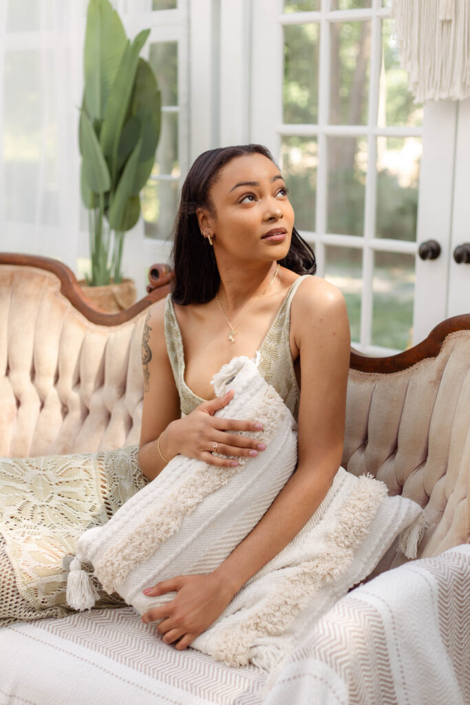 Editorial-style portrait of a model in a curated boho studio space