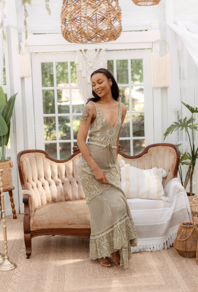 Model twirling in sage green dress for boho styled session