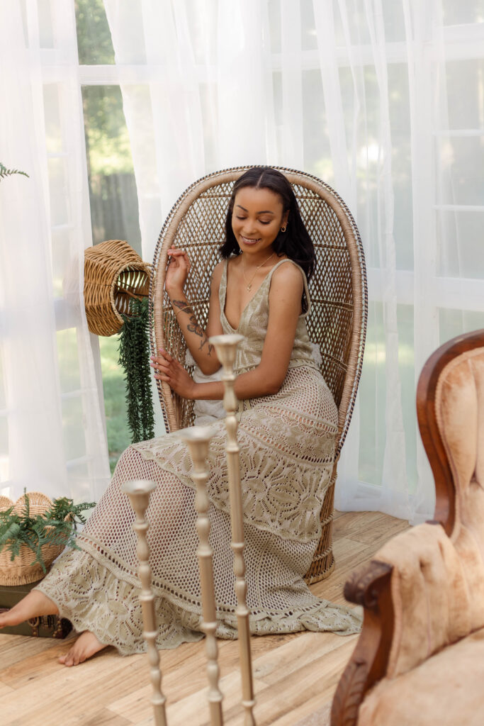 Model sitting in a rattan chair for boho styled session