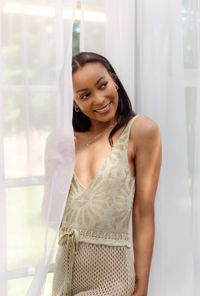 Model smiling in front of sheer white curtains in North Augusta photography studio