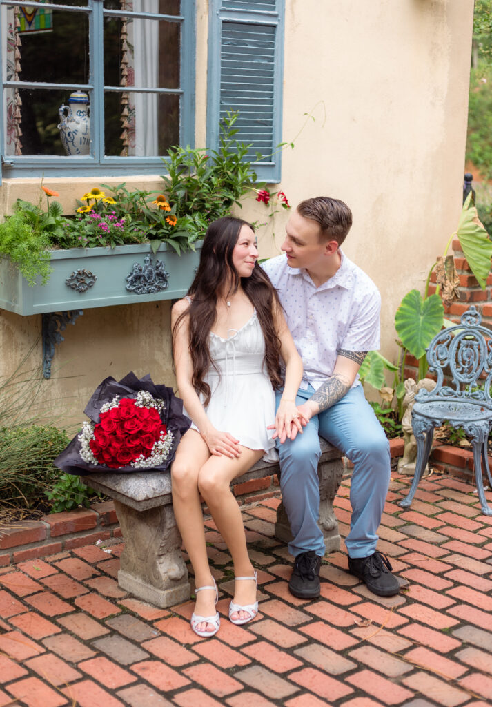 Couple sitting together on bench at Bath Gardens