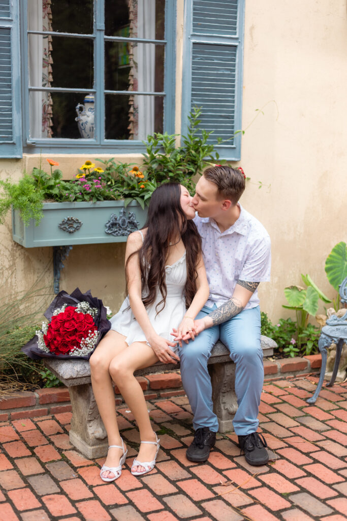 Couple kissing on a bench at a European style location
