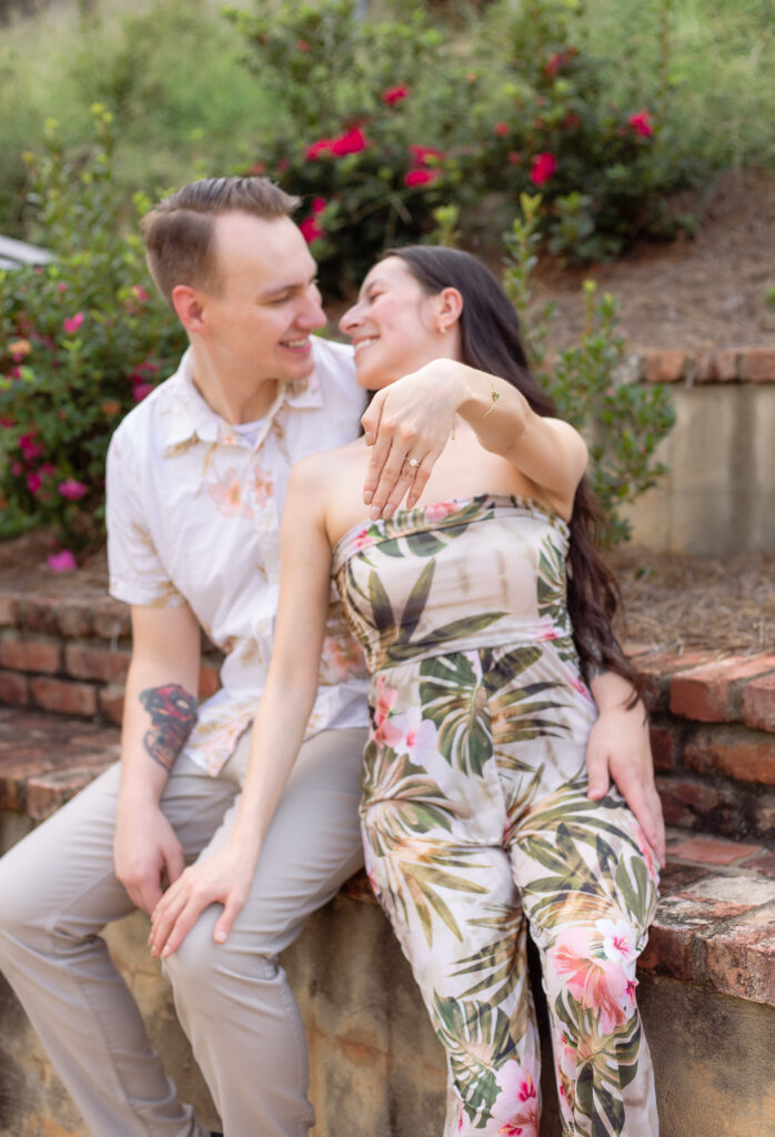 Woman shows off ring while smiling at her husband
