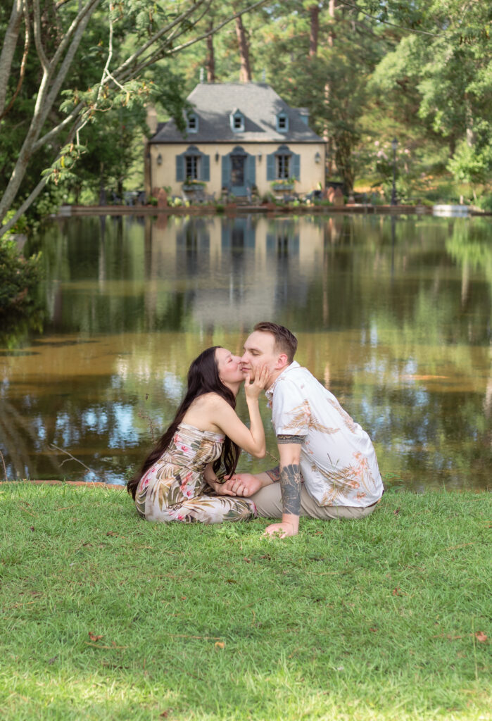 Woman kisses her partner's cheek with Bath Gardens European inspired house in the background