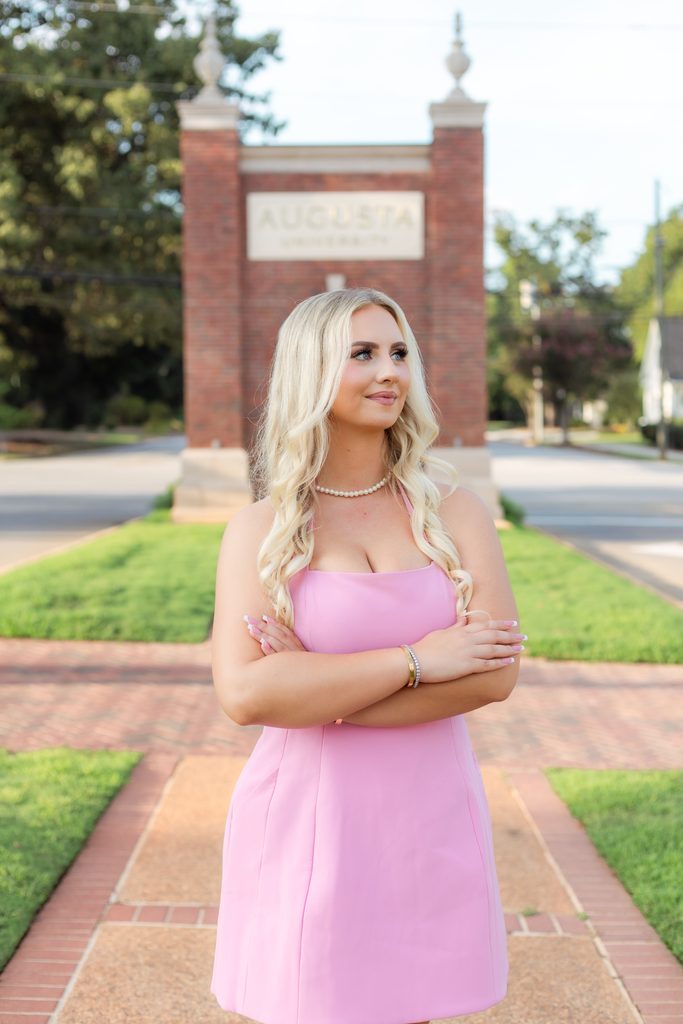 College grad folds arms while posing for photo session