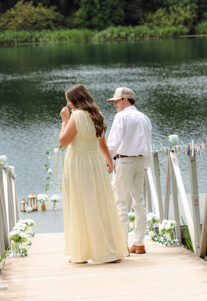 Man leads his girlfriend down to a dock to propose
