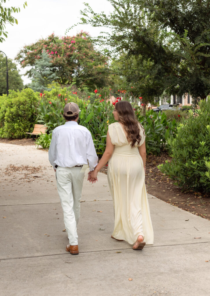 Engaged couple holding hands and walking together