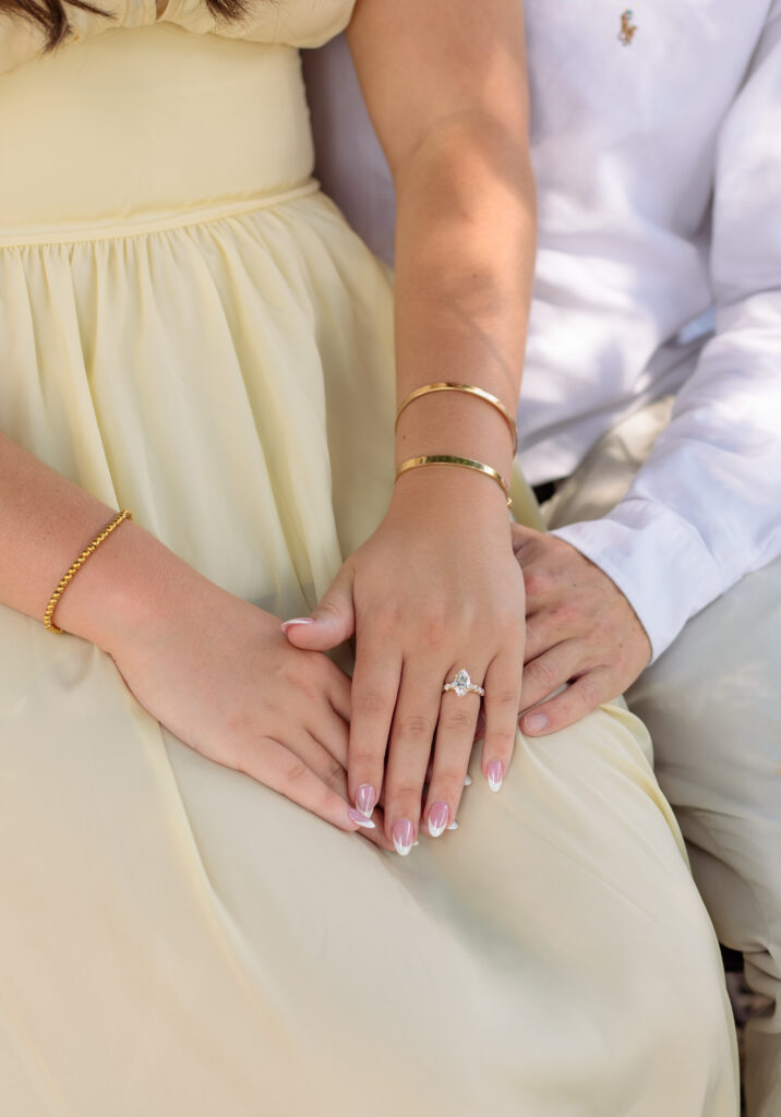 Close up of a couple's hands while showing engagement ring