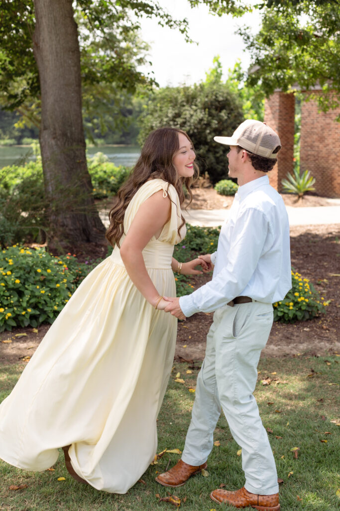 Engaged couple spins around excitedly for photo session